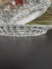Vintage clear glass dessert set with diamond cut pattern, including bowls, saucers, and a serving plate