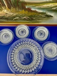 Vintage clear glass dessert set with diamond cut pattern, including bowls, saucers, and a serving plate