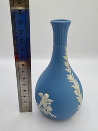 Collectible Wedgwood blue jasperware bud vase featuring white neoclassical motif and tapered design