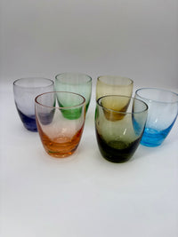 Set of six colorful glass tumblers on a white background