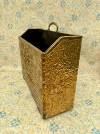 Vintage embossed brass magazine rack featuring a 1960s tavern scene