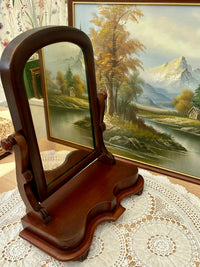 Side view of antique Victorian mahogany mirror showing scroll supports