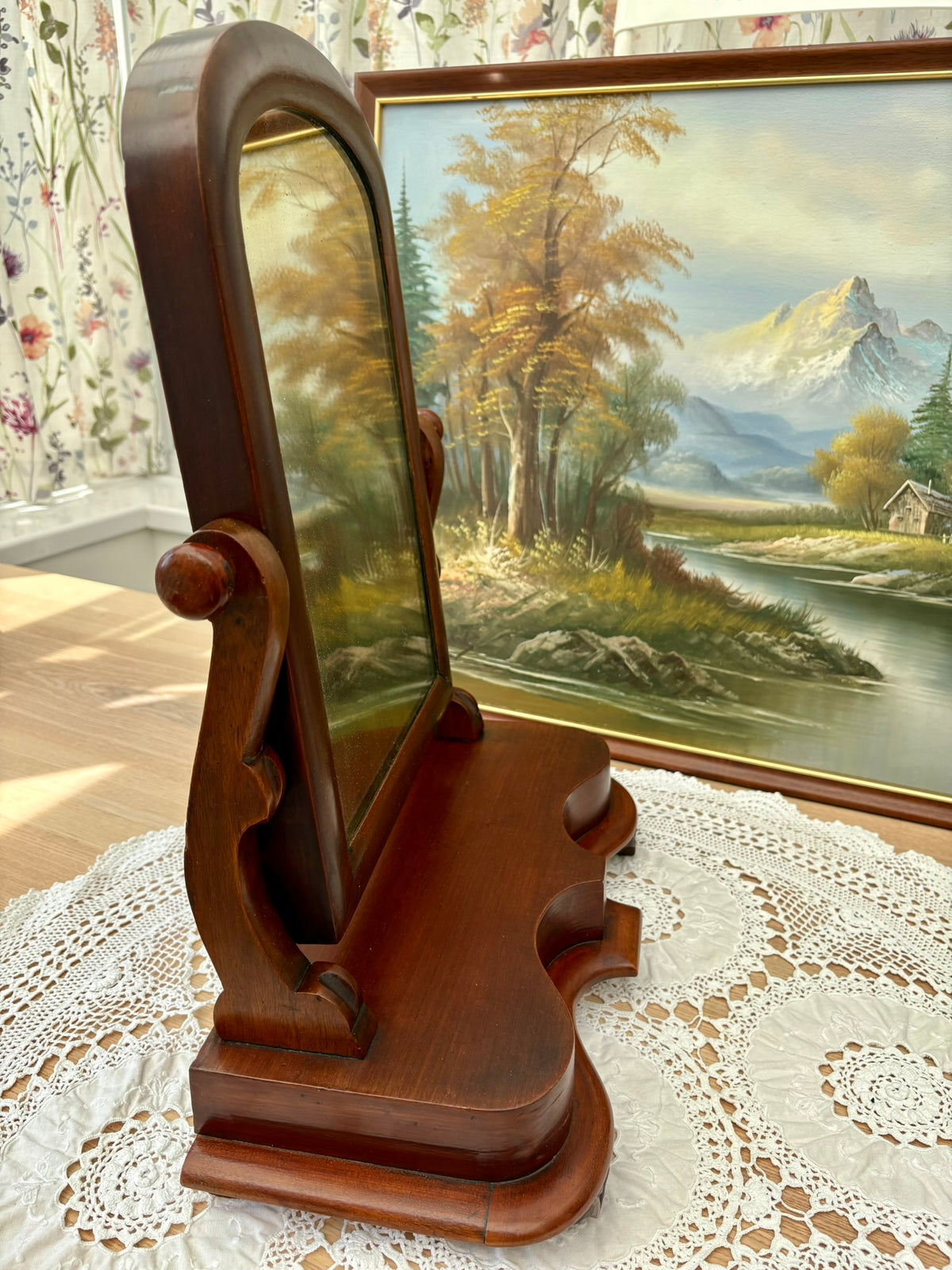 Side view of antique Victorian mahogany mirror showing scroll supports