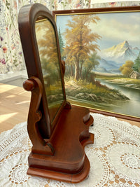 Side view of antique Victorian mahogany mirror showing scroll supports
