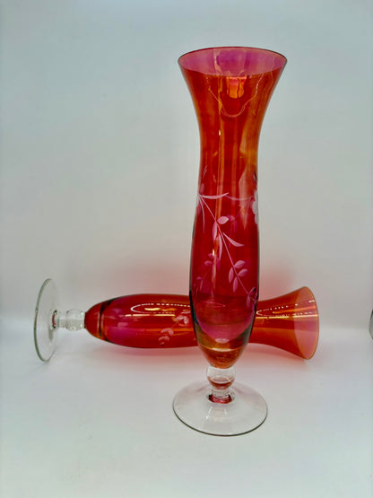 Red glass vase with engraved design on a white background