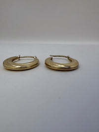 Pair of gold hoop earrings on a white background