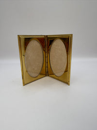 Gold compact frame on a white background