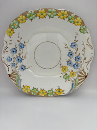 Decorative ceramic saucer with floral patterns on a white background