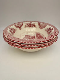 Set of three red and white patterned bowls on a light gray background