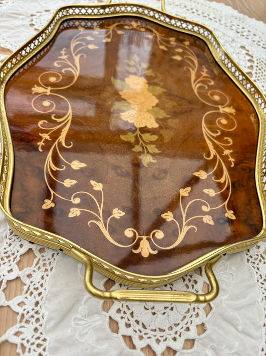 Decorative tray with gold leaf patterns on a lace surface