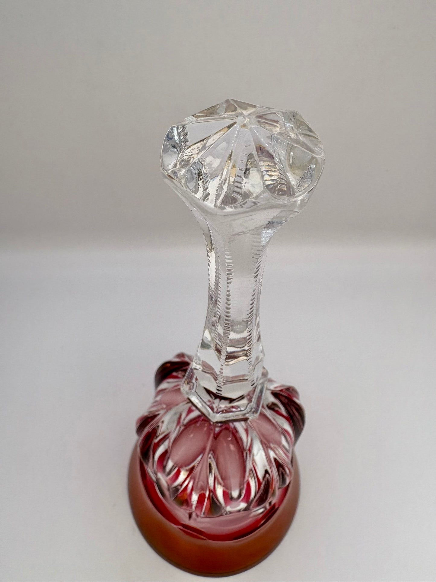 Vintage red and clear crystal bell ornament without ringer on display
