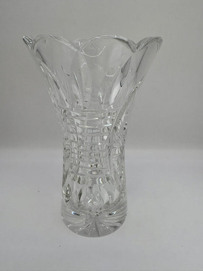 Clear glass vase with textured design on a gray background
