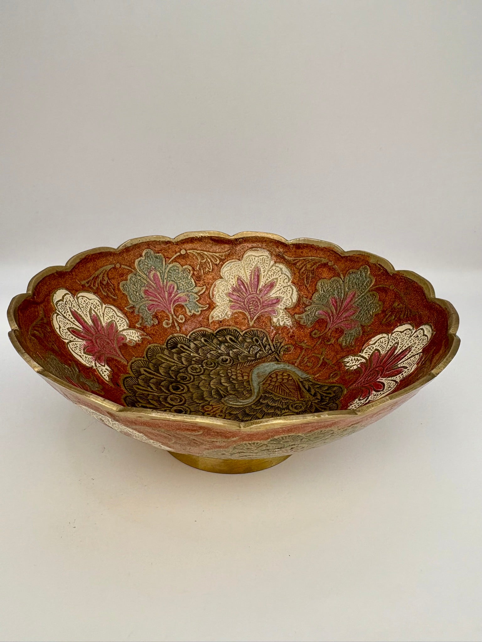 Decorative bowl with peacock design on a white background