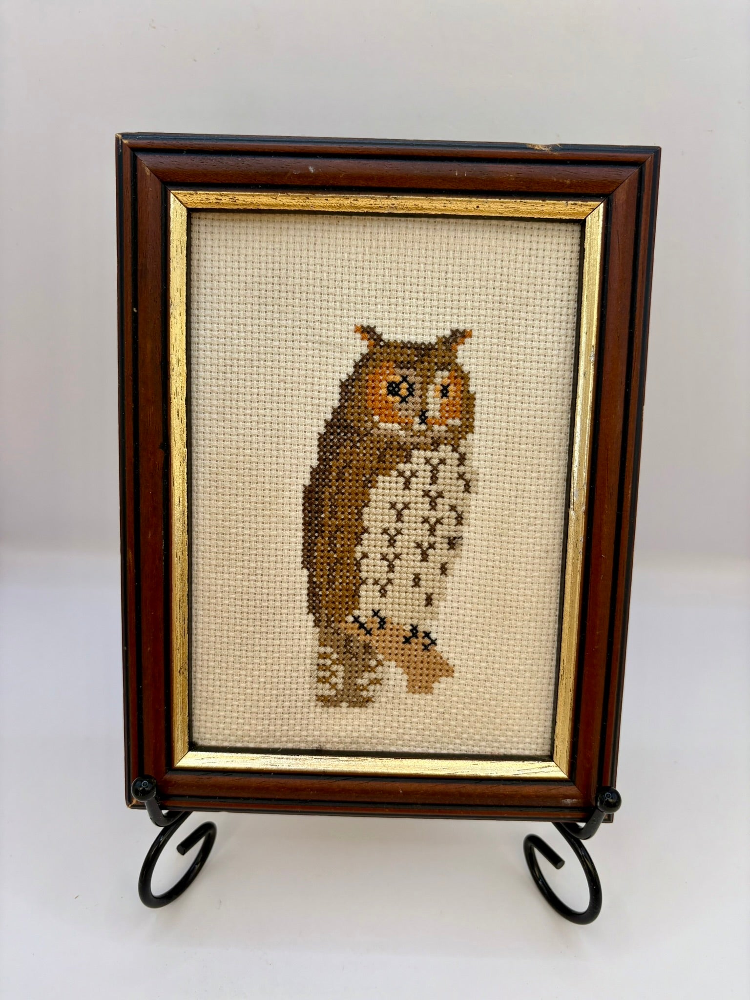 Framed cross-stitched owl on a white background