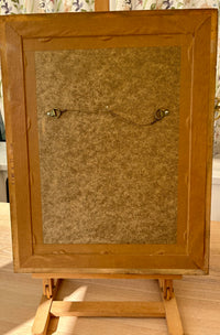 Wooden picture frame on a wooden easel with a textured brown background