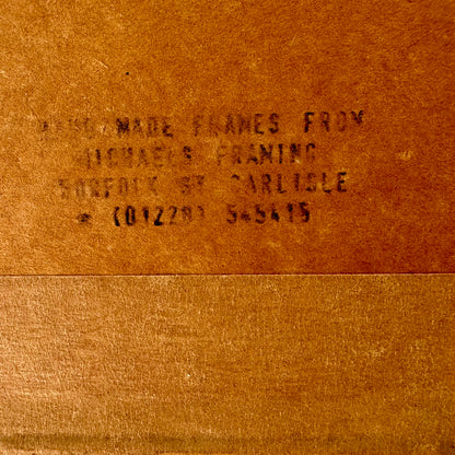 Text on a brown leather surface, likely indicating a brand or product name.