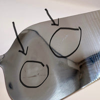 Metallic surface with black outlines of some scratches