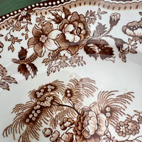 Floral pattern on a ceramic plate with brown ink