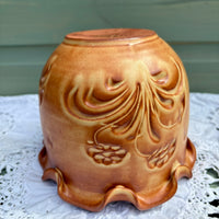 Ceramic vase with floral patterns on a lace tablecloth