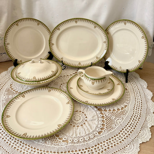 Set of ceramic plates and a pitcher on a lace tablecloth