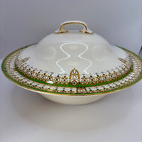 Decorative ceramic dish with a lid featuring intricate gold and green patterns on a white background.