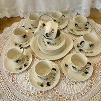 Tea set with floral patterns on a lace tablecloth