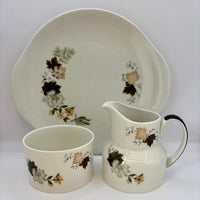 Ceramic tableware set with floral patterns on a white background