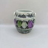 Ceramic vase with geometric design on a white background