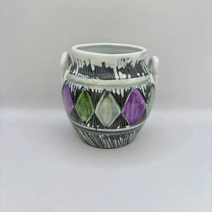 Ceramic vase with geometric design on a white background