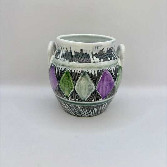Ceramic vase with geometric design on a white background