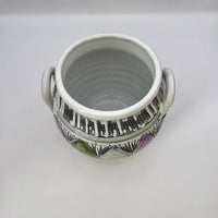 Ceramic pot with handles on a white background