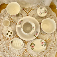 Ceramic set with floral patterns on a lace tablecloth