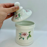 Ceramic jar with floral designs on a white background