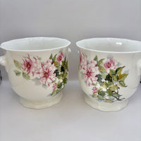 Two floral ceramic vases on a white background