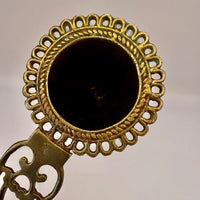Decorative bronze key with intricate design on a plain background
