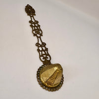 Decorative gold spoon on a white background