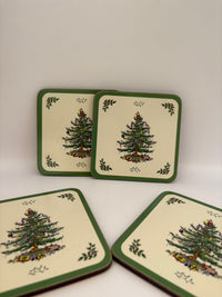 Set of four coasters with Christmas tree design on a white background