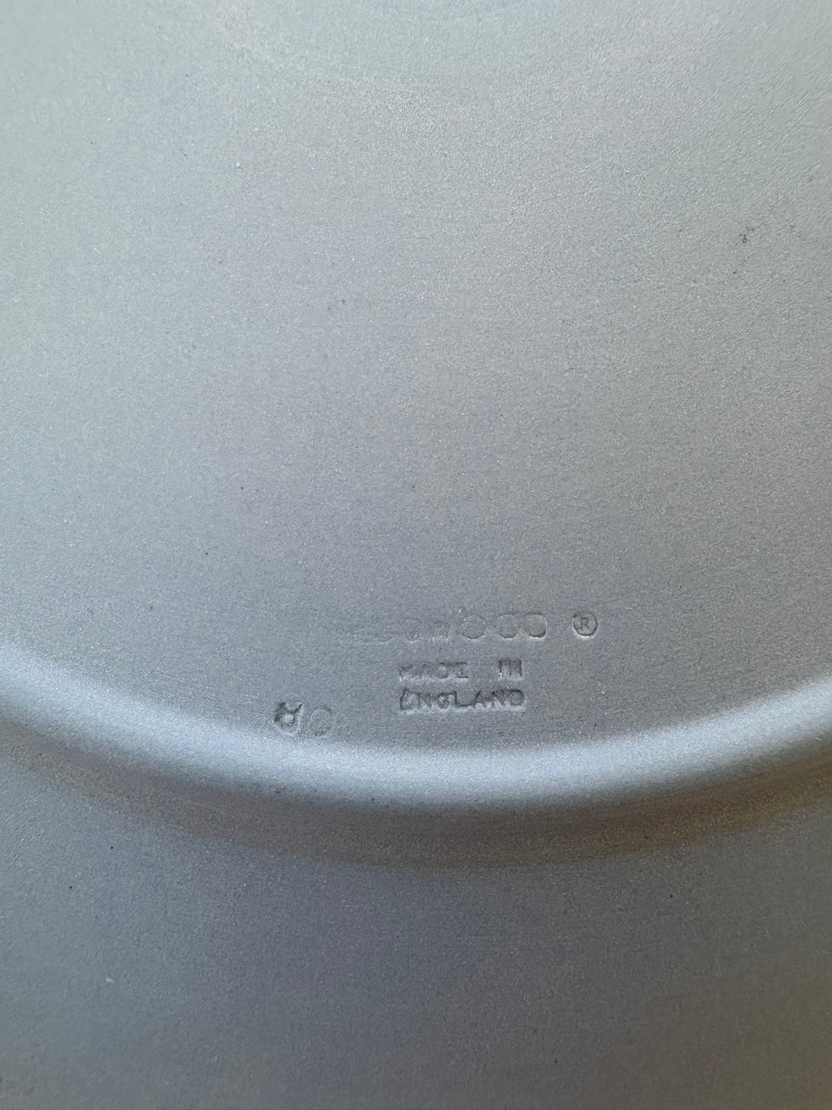 Close-up of a white ceramic plate with 'Ceramic' and 'Made in England' text.