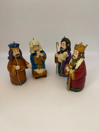 Four figurines of the Three Wise Men and a Woman on a white background