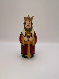 Decorative figurine of a king with a crown and robe on a white background