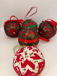 Decorative Christmas ornaments with red and green ribbons on a white background