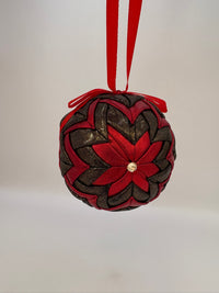 Decorative ornament with red and brown braided design on a white background