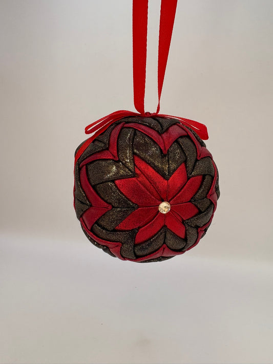 Decorative ornament with red and brown braided design on a white background