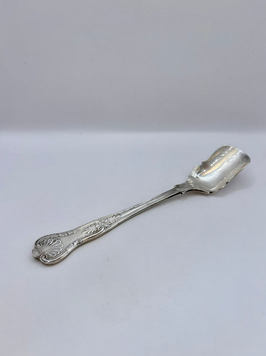 Silver spoon on a light gray background