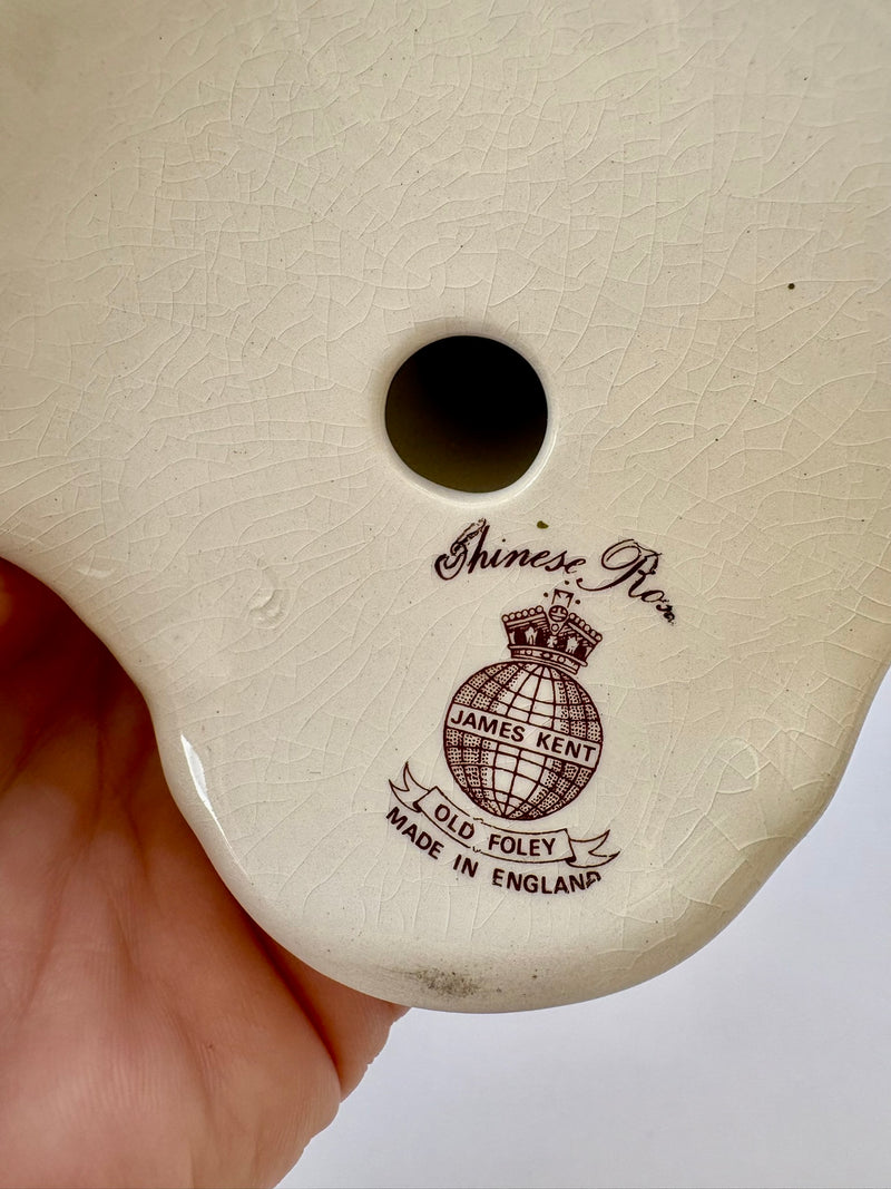 Close-up of a beige product with 'Chinese Rose' branding on a white background.