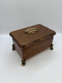 Wooden jewelry box with brass accents on a white background