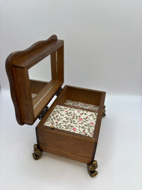 Wooden jewelry box with floral interior on a white background
