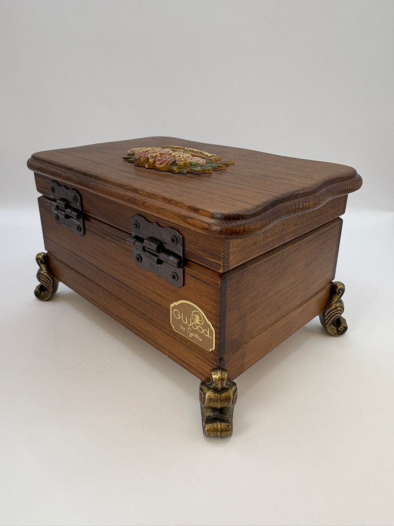 Wooden jewelry box with brass accents on a white background