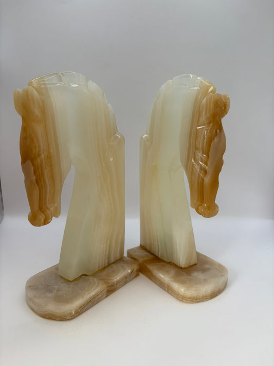 Pair of onyx horse head bookends on a white background
