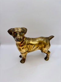 Brass dog figurine on a white background
